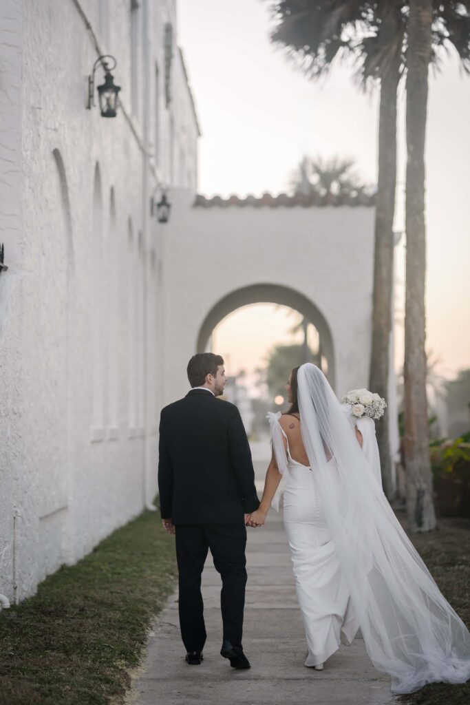 Candid photos of the bride and groom walking at Casa Marina Jacksonville Florida