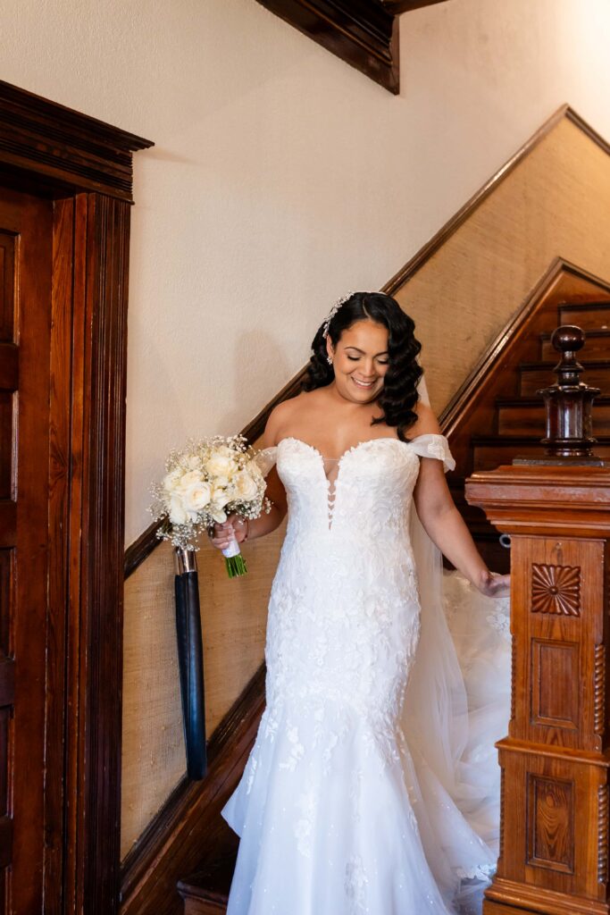Candid moment of bride walking down the stairs at the Highland Manor, photographed by Phavy Photography, Orlando wedding photographer