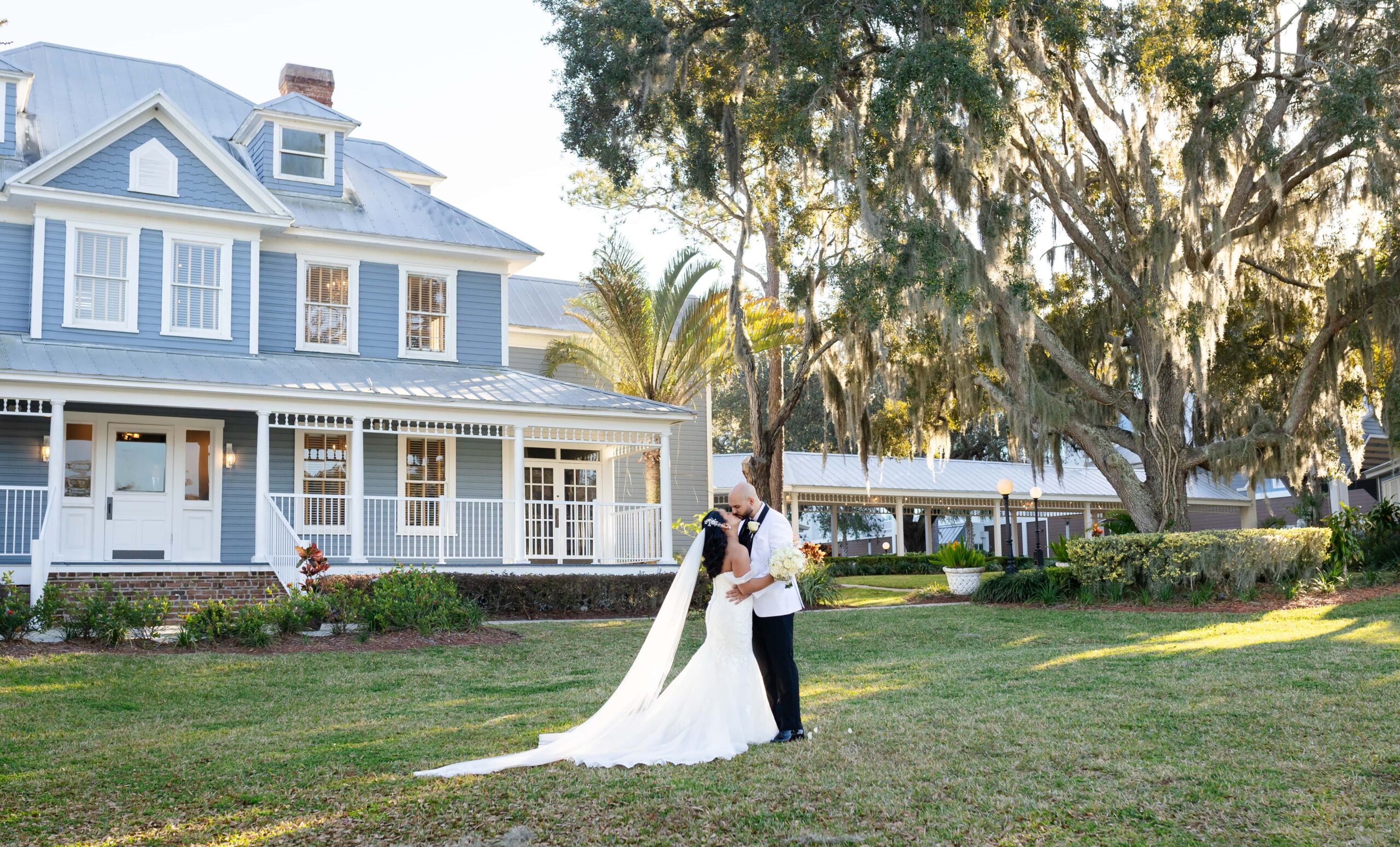 Bride and groom wedding photo in front of The Highland Manor Apopka, Florida