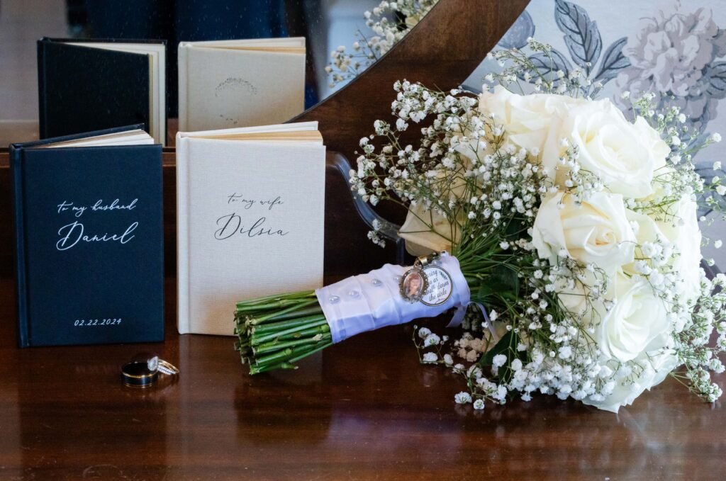Detail wedding shot with the vow books, rings, and the bouquet | Wedding Photos by Phavy Photography - Orlando Wedding Photographer