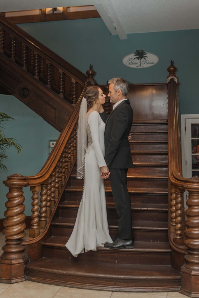 Bride and groom in front of the iconic stairway at the White Room, St. Augustine Florida