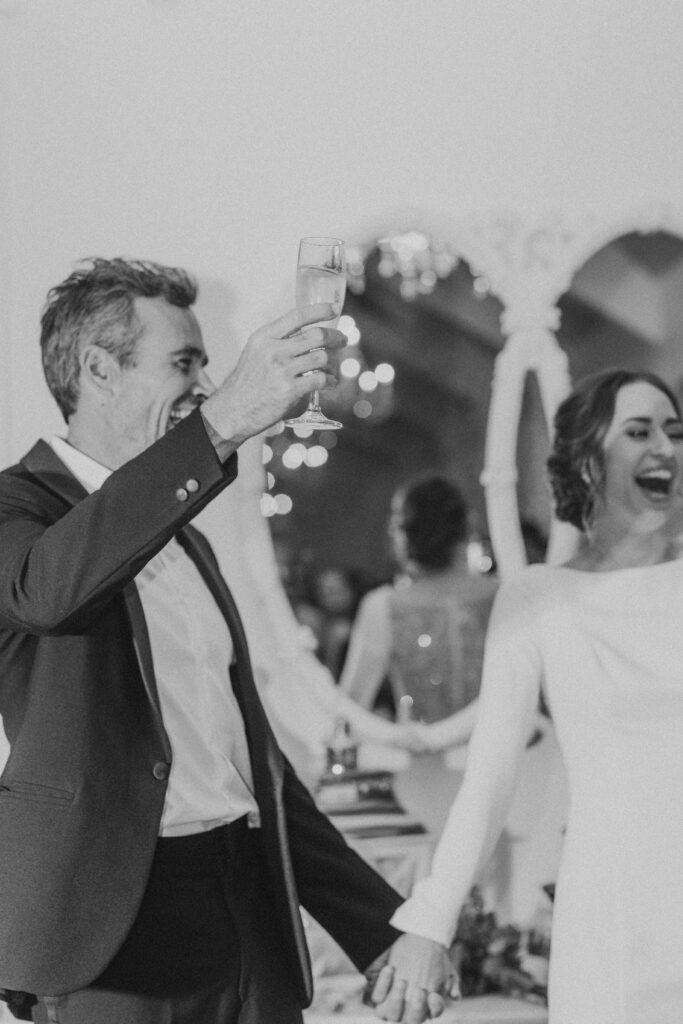 Bride and groom toasting at their wedding reception at the White Room, St. Augustine