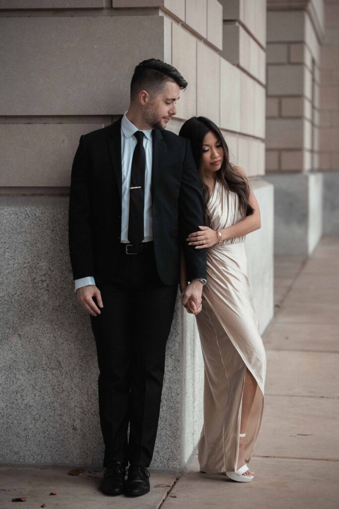 Groom in suit and bride-to-be in satin dress holding hands | Engagement session in Jacksonville, FL