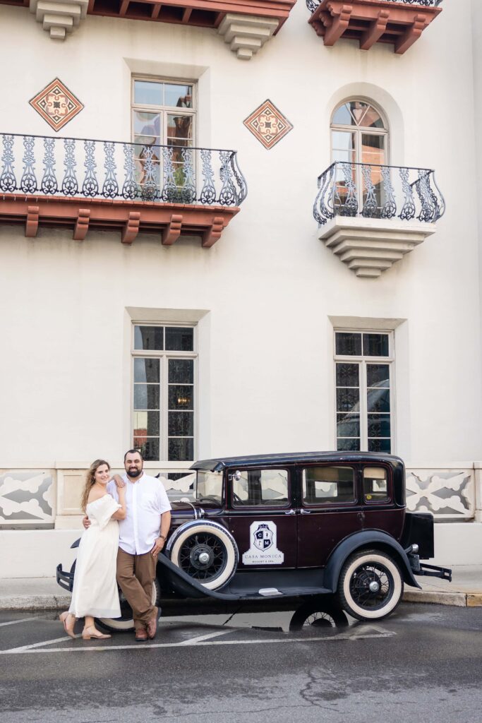 Engagement photos in front of Casa Monica's vintage car in St. Augustine