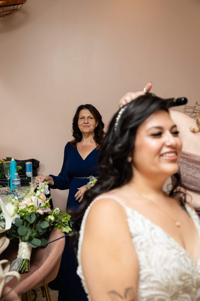 Mother admiring her daughter, the bride while getting her hair done for her wedding at the Treasury, St. Augustine