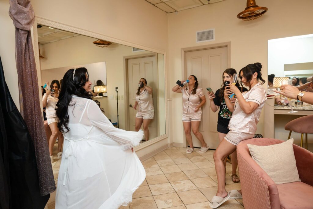 Bridesmaids taking photos of the lovely bride at The Treasury on the Plaza, St. Augustine