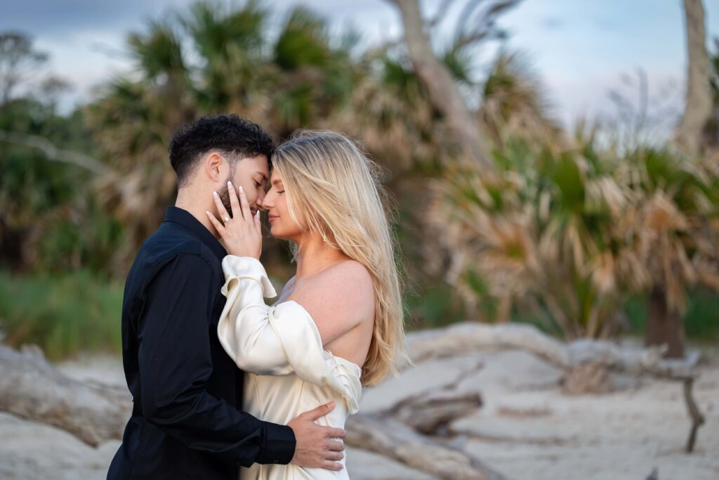 Intimate moment between couple during engagement session in Jekyll Island, GA