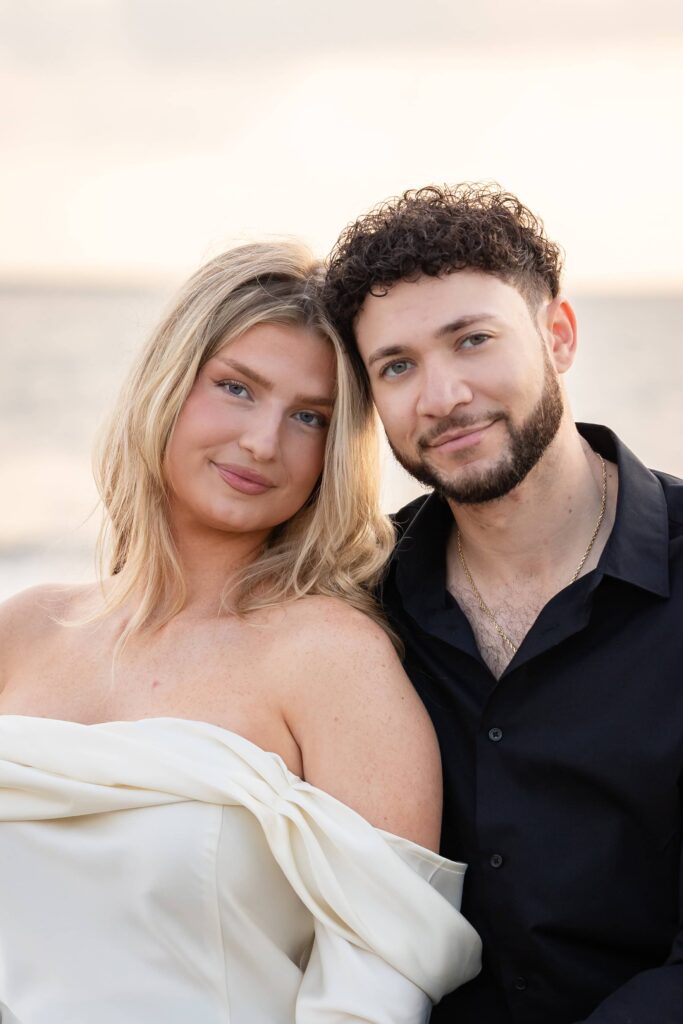 Bride-to-be and fiancé posing during a dreamy sunset engagement session