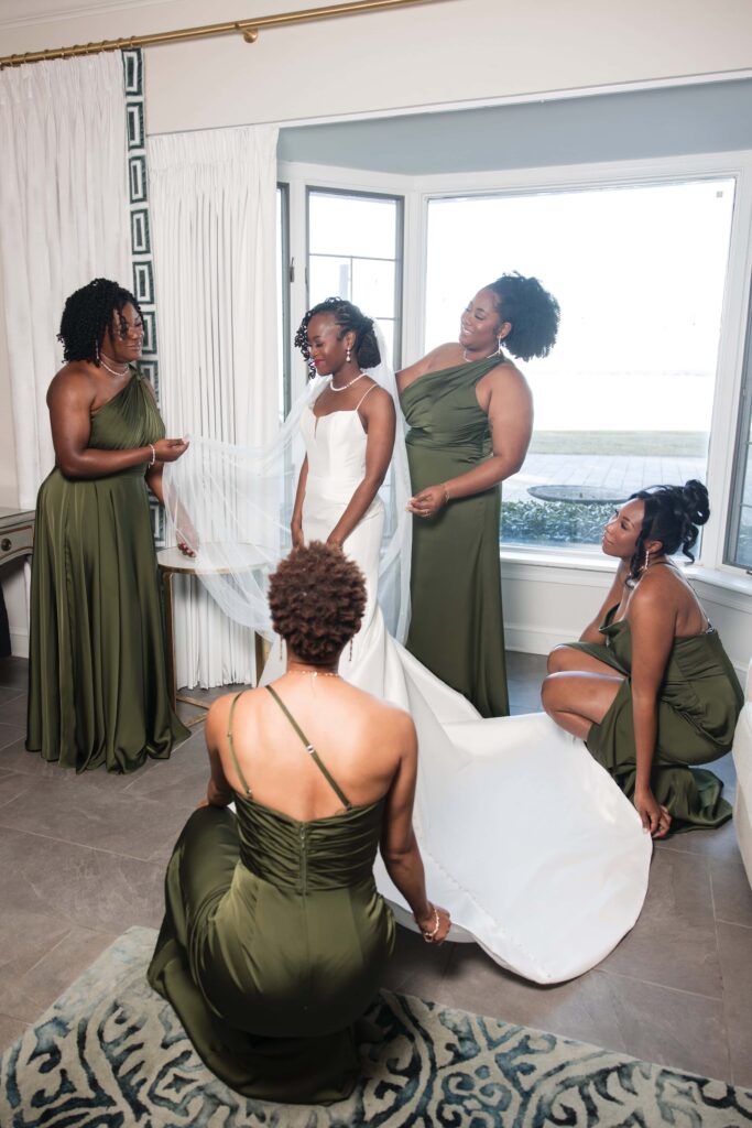 Bride getting ready with bridesmaids in green dresses at Azaleana Manor in Orange Park, Florida.