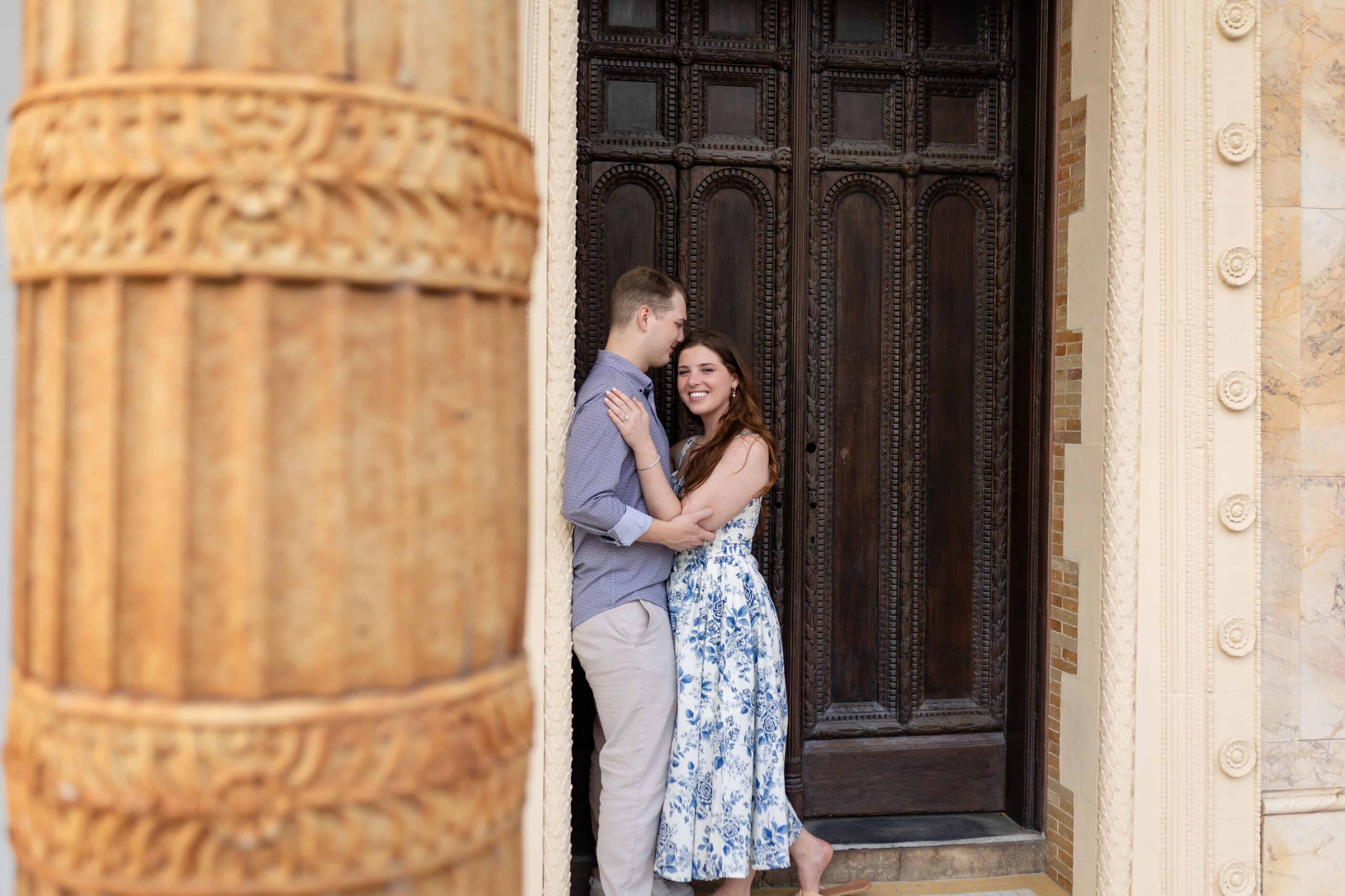 Classic St. Augustine engagement photo with intricate architecture and soft, romantic posing