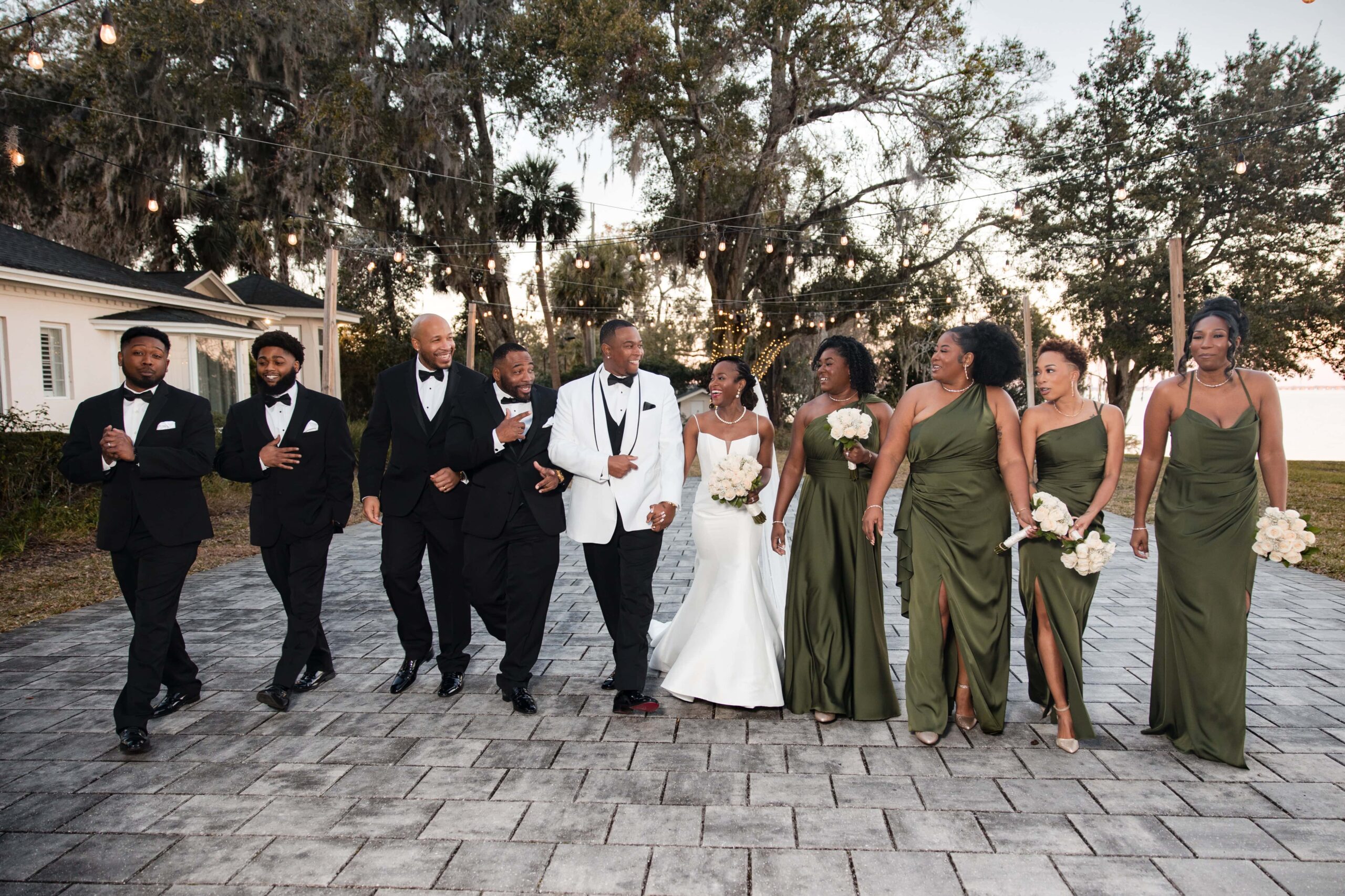 Bride and groom celebrating with bridal party at Azaleana Manor in Orange Park, Florida