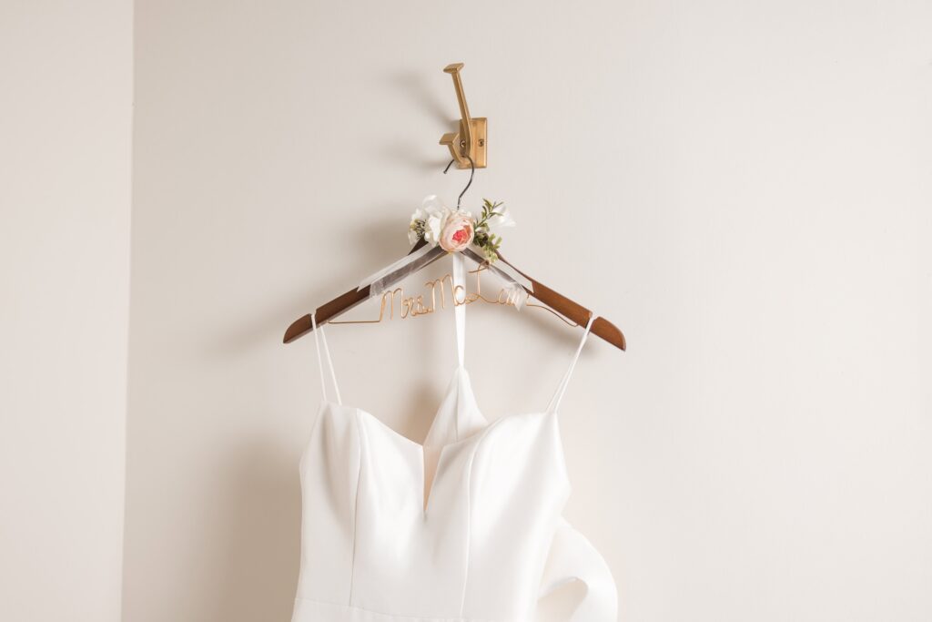 Elegant bridal gown hanging on a personalized floral hanger in Orange Park, FL.