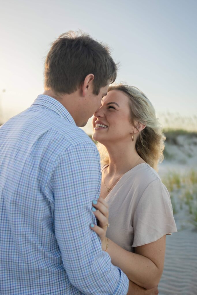 St Augustine Beach engagement photographer capturing a couple on the dunes"
