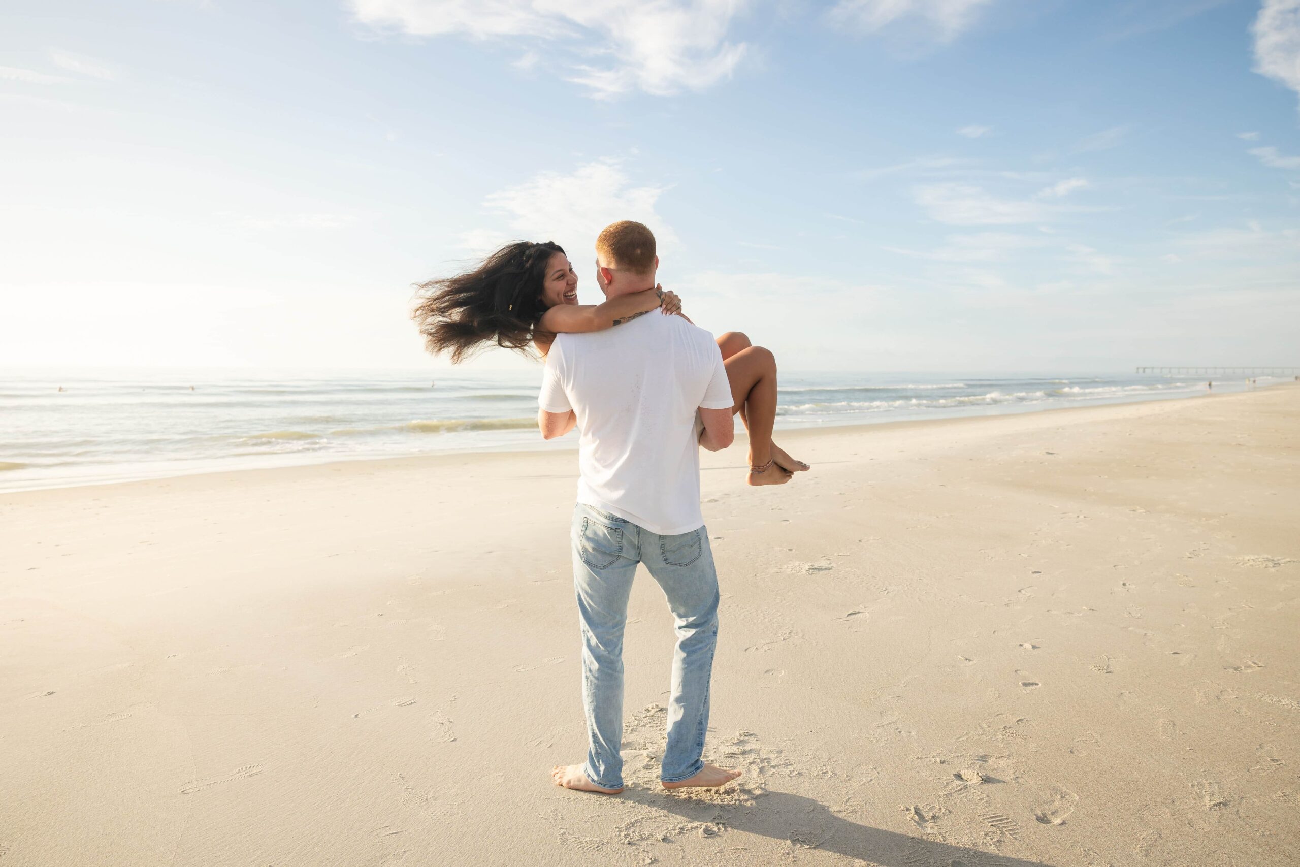 Phavy Photography captured this candid moment during a Jacksonville Beach engagement session—full of light, movement, and connection.