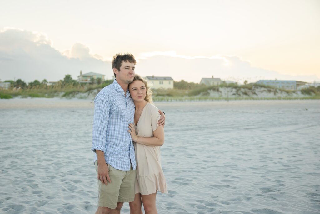 St Augustine couple looking towards the ocean during an engagement session. Candid moments.