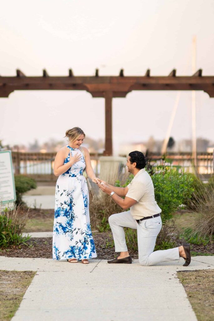 A proposing in St. Augustine at the bay front | Sunset proposal Captured by Phavy Photography, St. Augustine Proposal Photographer