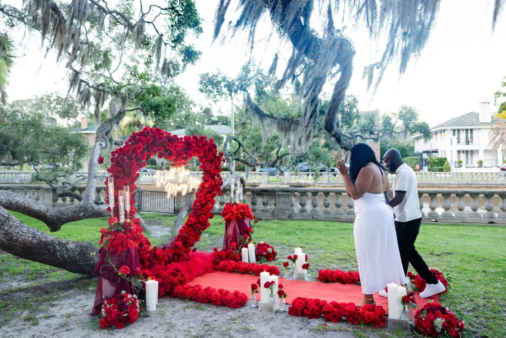 A man walking up to a beautiful proposal decor before proposing to his girlfriend