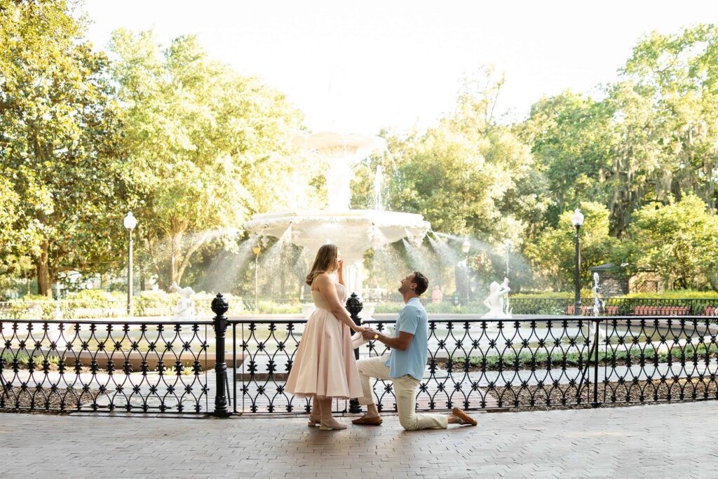 Man proposing to his girlfriend at Forsyth Park fountain in Savannah, Georgia.