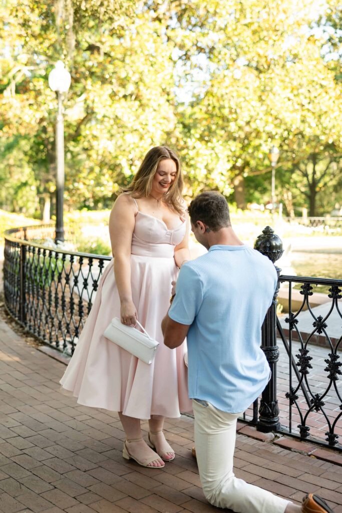 Emotional marriage proposal beneath the live oaks at Forsyth Park in Savannah.